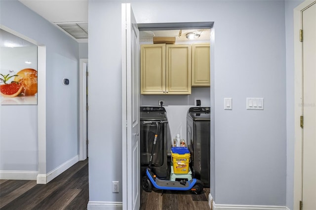 washroom featuring washer and clothes dryer, dark hardwood / wood-style floors, and cabinets