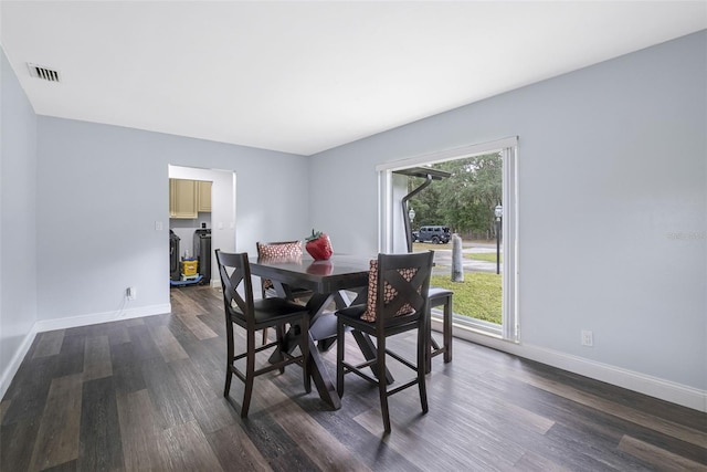 dining space with dark hardwood / wood-style flooring and separate washer and dryer