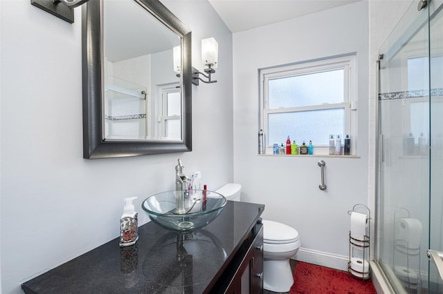 bathroom with vanity, toilet, and walk in shower