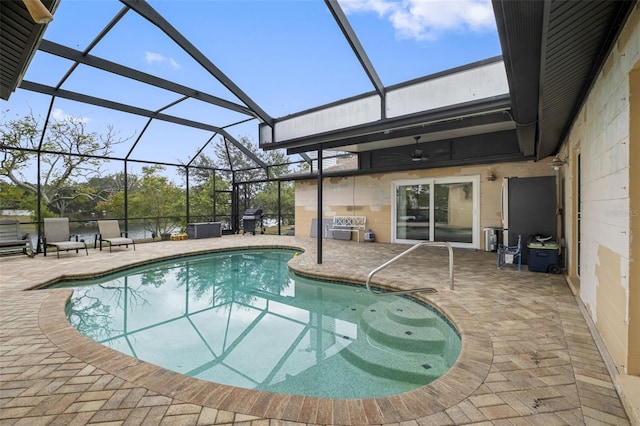 view of pool featuring a lanai, ceiling fan, area for grilling, and a patio area