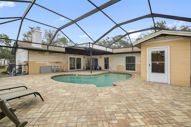 view of swimming pool with a patio and glass enclosure