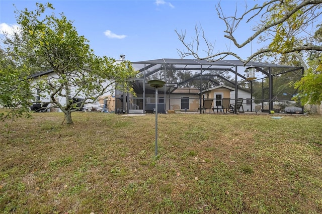 back of property featuring glass enclosure and a yard