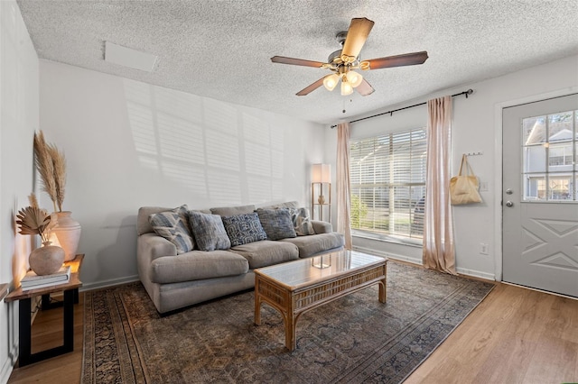 living room with plenty of natural light, wood-type flooring, and a textured ceiling