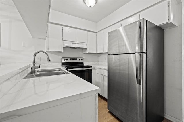 kitchen with white cabinetry, sink, light hardwood / wood-style flooring, and appliances with stainless steel finishes