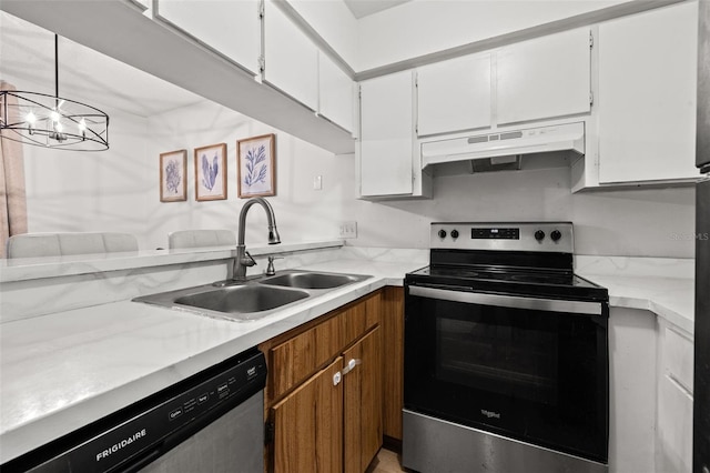 kitchen featuring an inviting chandelier, white cabinets, sink, hanging light fixtures, and stainless steel appliances