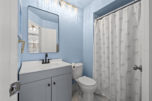 bathroom with vanity, toilet, and curtained shower