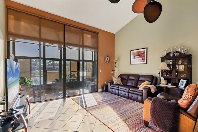 living room featuring ceiling fan, light tile patterned flooring, and high vaulted ceiling