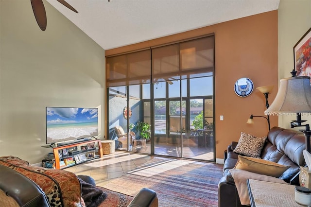 living room featuring tile patterned flooring, high vaulted ceiling, and ceiling fan