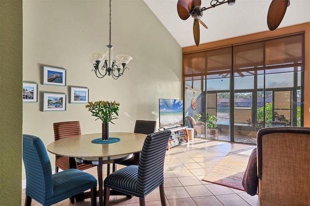 tiled dining room featuring ceiling fan with notable chandelier and high vaulted ceiling