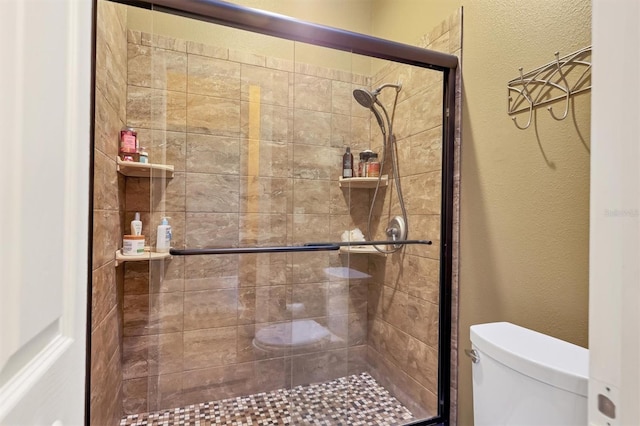 bathroom featuring toilet and walk in shower