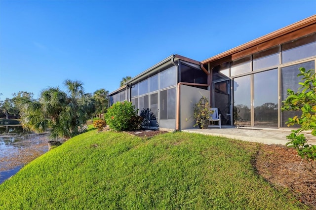 4542 Park Lake Ter N Unit 4542, Bradenton, FL 34209 - view of grassy yard with a sunroom and a water view