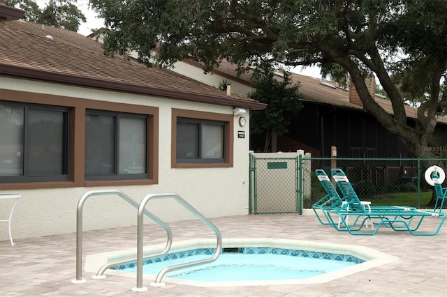 view of pool featuring an in ground hot tub