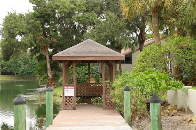 view of dock featuring a gazebo and a water view