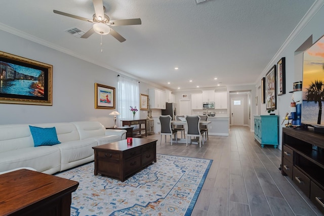 16819 Shell Bay Dr, Land O Lakes, FL 34638 - living area with ornamental molding, a ceiling fan, wood finished floors, and recessed lighting