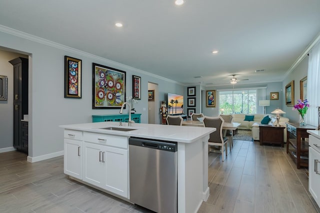 16819 Shell Bay Dr, Land O Lakes, FL 34638 - kitchen featuring dishwasher, a sink, an island with sink, a ceiling fan, and crown molding