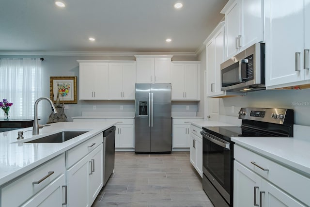 16819 Shell Bay Dr, Land O Lakes, FL 34638 - kitchen featuring stainless steel appliances, a sink, light countertops, crown molding, and white cabinets