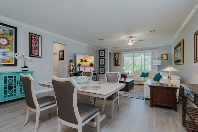16819 Shell Bay Dr, Land O Lakes, FL 34638 - dining space featuring light wood-style flooring, ceiling fan, ornamental molding, and baseboards