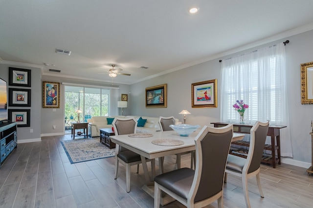 16819 Shell Bay Dr, Land O Lakes, FL 34638 - dining room with a ceiling fan, ornamental molding, baseboards, and wood finished floors