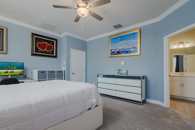 16819 Shell Bay Dr, Land O Lakes, FL 34638 - carpeted bedroom with crown molding, a sink, ensuite bath, baseboards, and a textured ceiling