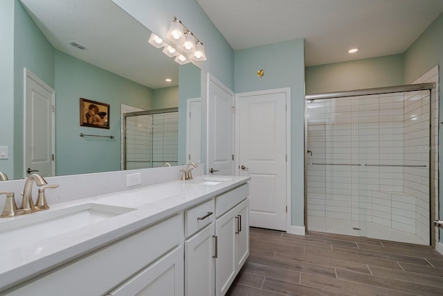 16819 Shell Bay Dr, Land O Lakes, FL 34638 - full bath with a shower stall, double vanity, wood tiled floors, and recessed lighting