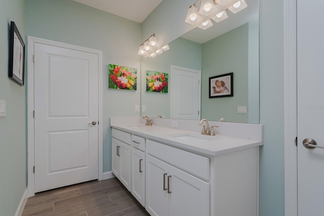 16819 Shell Bay Dr, Land O Lakes, FL 34638 - bathroom featuring double vanity, wood finished floors, and baseboards