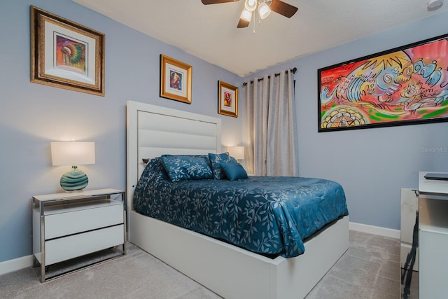 bedroom featuring ceiling fan and light carpet