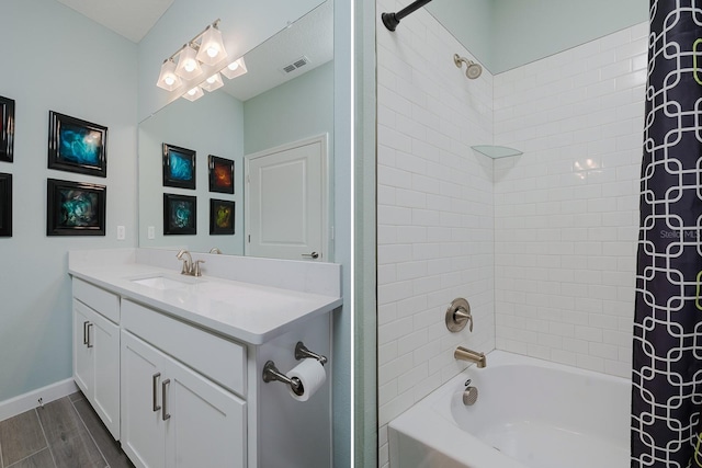 16819 Shell Bay Dr, Land O Lakes, FL 34638 - full bathroom featuring shower / bathtub combination with curtain, vanity, wood finished floors, and baseboards