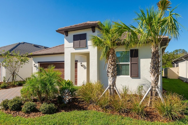 16819 Shell Bay Dr, Land O Lakes, FL 34638 - view of front of home featuring stucco siding, an attached garage, and a tiled roof