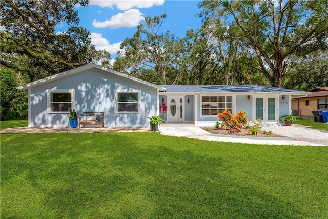 back of property featuring a yard and french doors