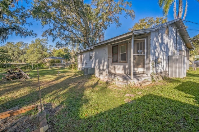 view of side of home with a lawn