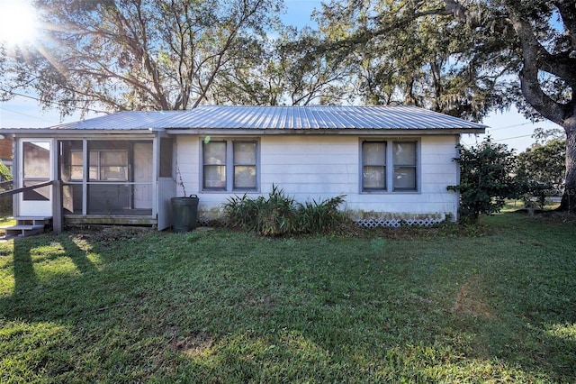 single story home with a sunroom and a front lawn