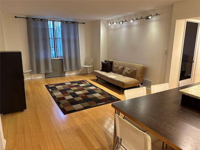 living room featuring track lighting and light hardwood / wood-style flooring