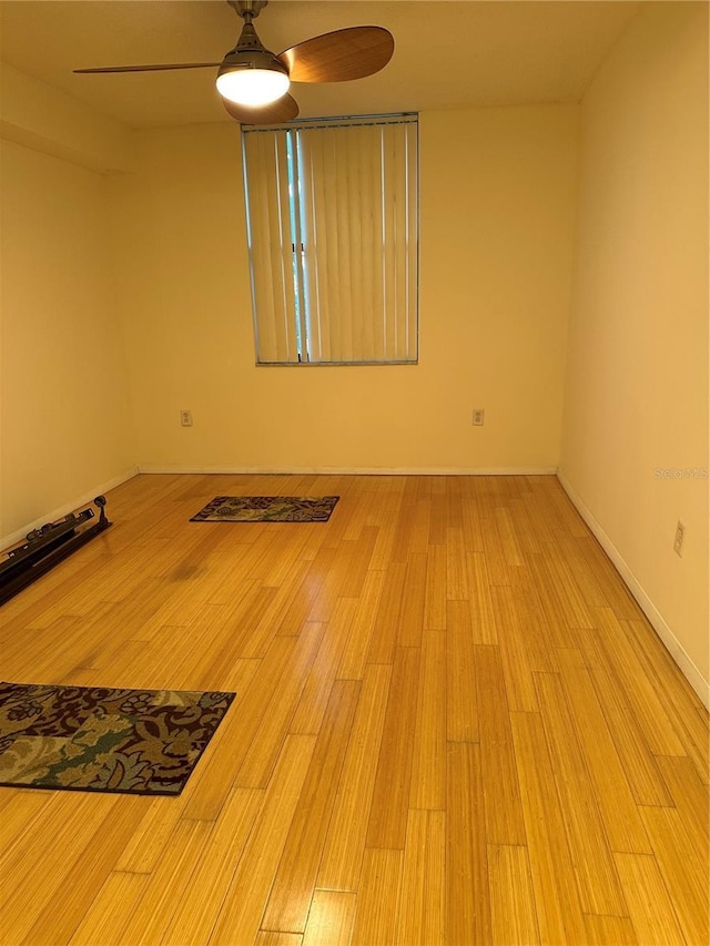 spare room featuring ceiling fan and wood-type flooring