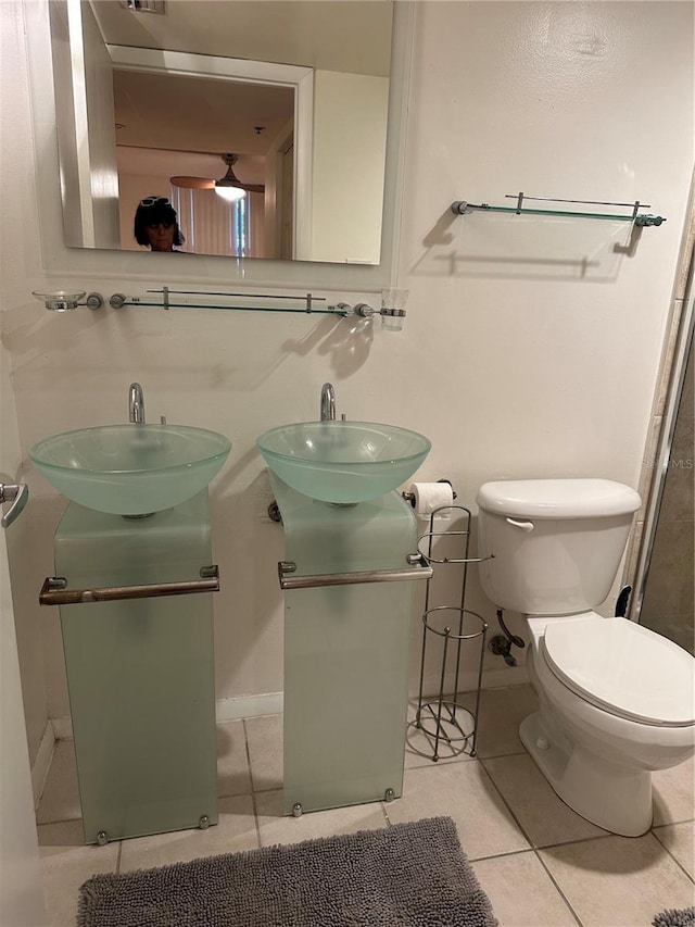 bathroom featuring toilet, vanity, and tile patterned floors