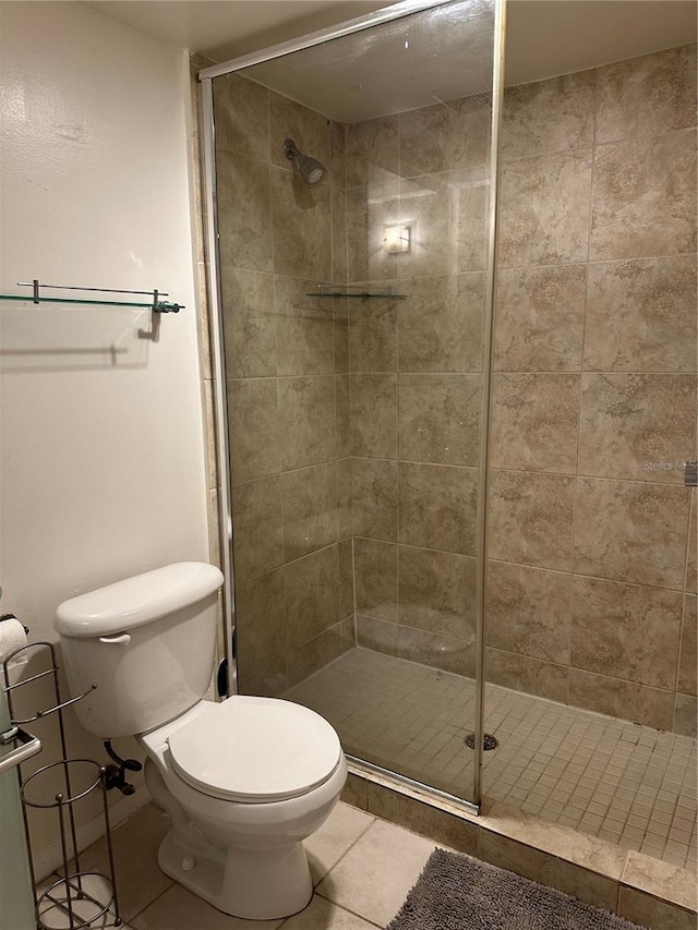 bathroom with tile patterned floors, toilet, and walk in shower