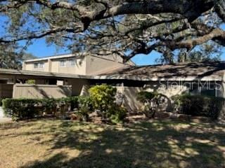 view of side of home with a lawn