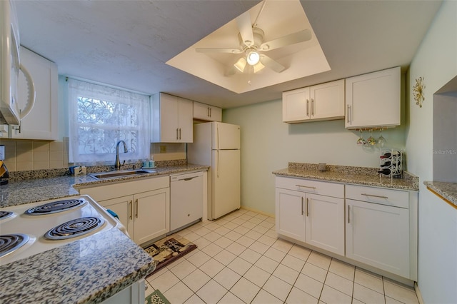 kitchen featuring white appliances, white cabinets, sink, ceiling fan, and light tile patterned floors