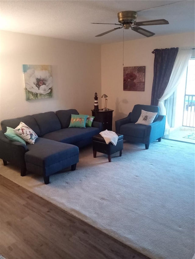 living room featuring ceiling fan and wood-type flooring