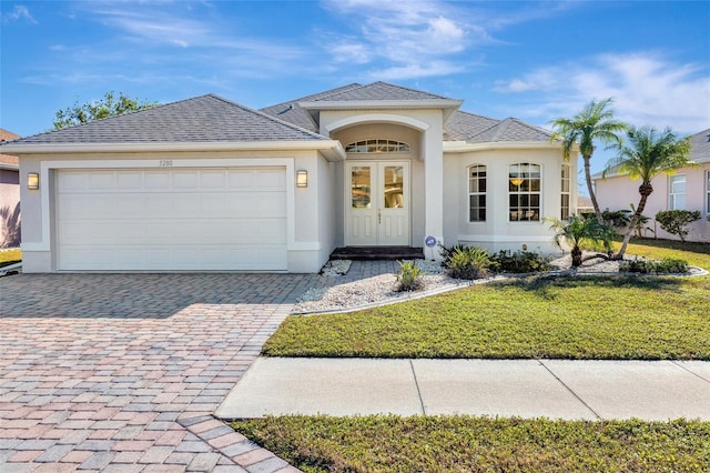 view of front facade with a front lawn and a garage