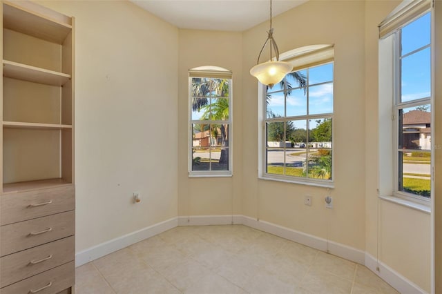 tiled spare room with plenty of natural light