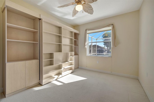 interior space featuring ceiling fan and light carpet