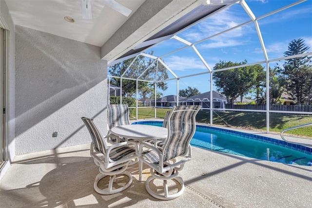 view of pool featuring glass enclosure and a patio