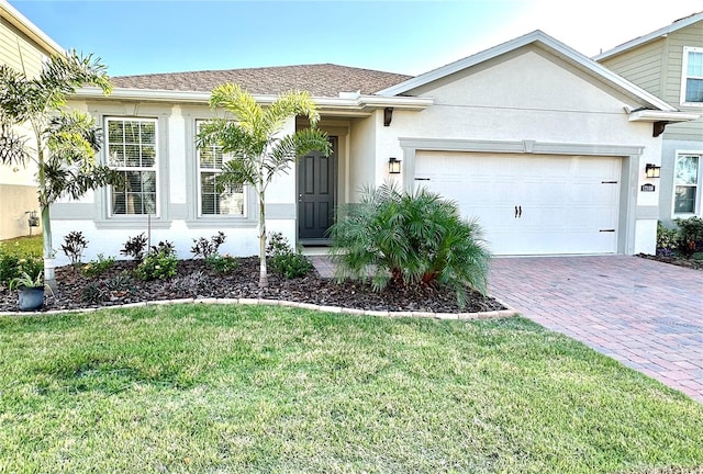 view of front of home featuring a front yard and a garage