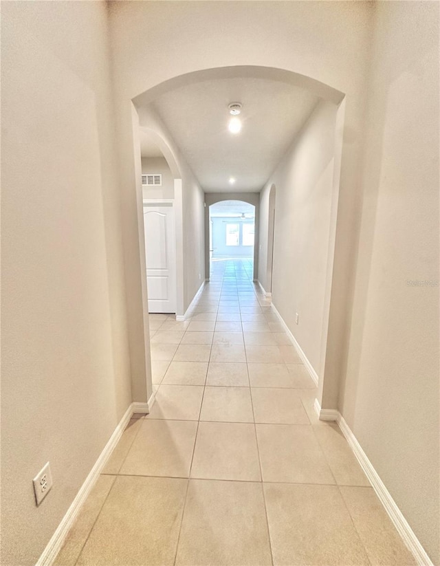 hall featuring light tile patterned floors