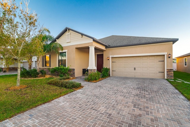 view of front of property featuring a front yard and a garage