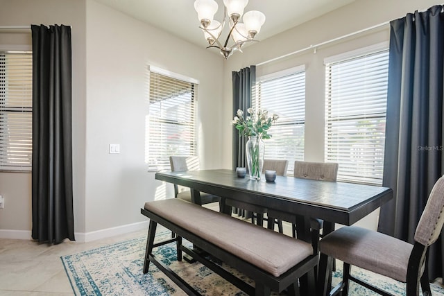 dining room with light tile patterned floors, a wealth of natural light, and a notable chandelier