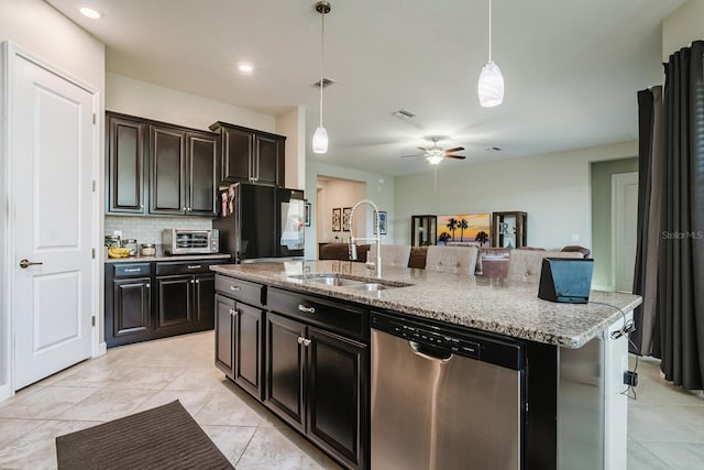 kitchen featuring pendant lighting, a kitchen island with sink, sink, stainless steel dishwasher, and ceiling fan