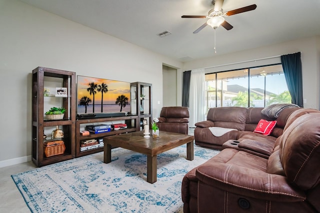 living room with ceiling fan and a baseboard heating unit