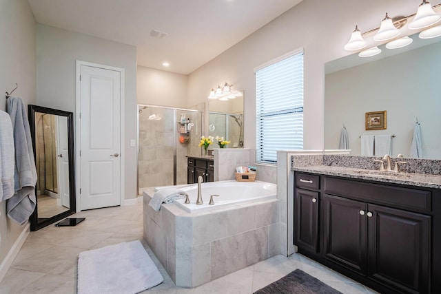 bathroom featuring vanity and independent shower and bath