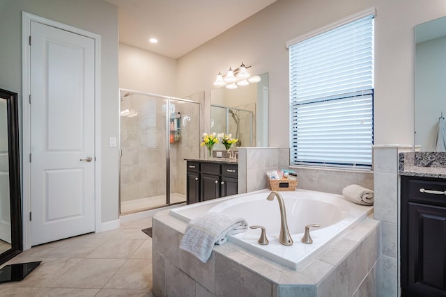 bathroom with tile patterned flooring, vanity, and independent shower and bath